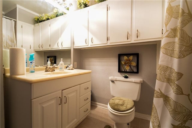 bathroom with tile patterned flooring, vanity, and toilet