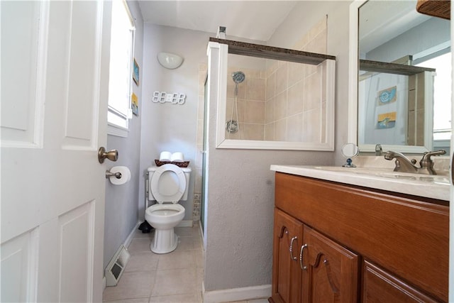 bathroom with tile patterned floors, vanity, toilet, and a shower with door