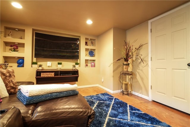 sitting room featuring built in shelves