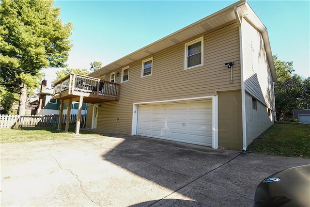 back of house with a garage and a deck