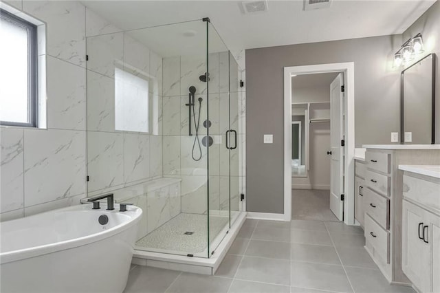 bathroom with vanity, tile patterned flooring, and shower with separate bathtub