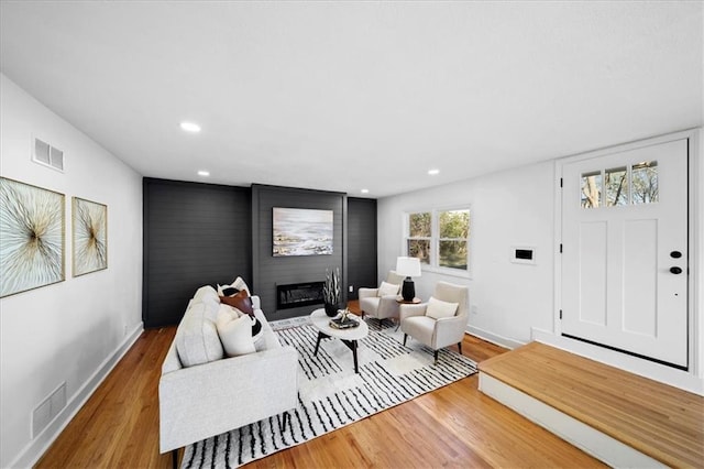 living room with a fireplace and hardwood / wood-style flooring