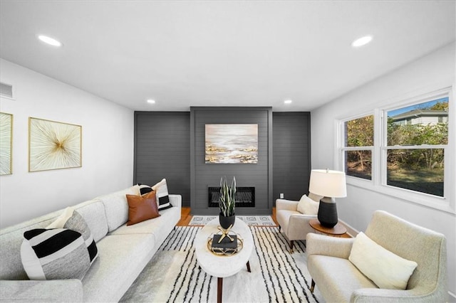 living room featuring wood-type flooring and a fireplace