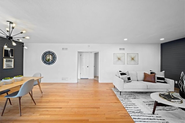 living room featuring light hardwood / wood-style flooring and a chandelier