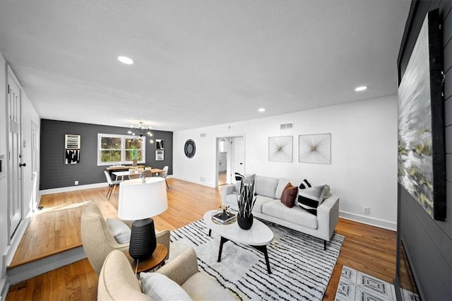 living room featuring hardwood / wood-style floors and a notable chandelier