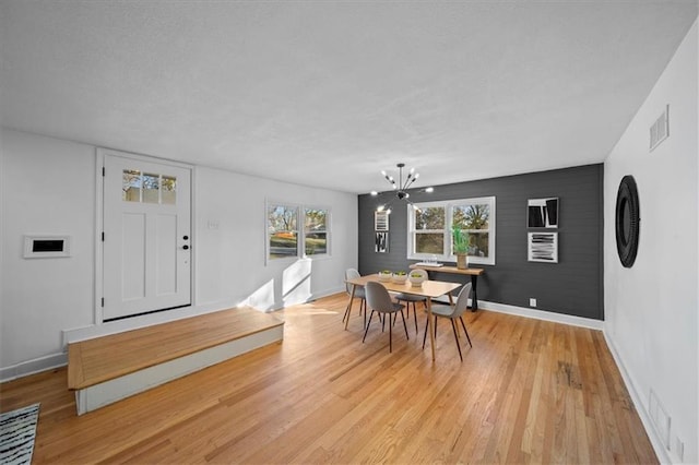 dining room with a notable chandelier and light hardwood / wood-style flooring