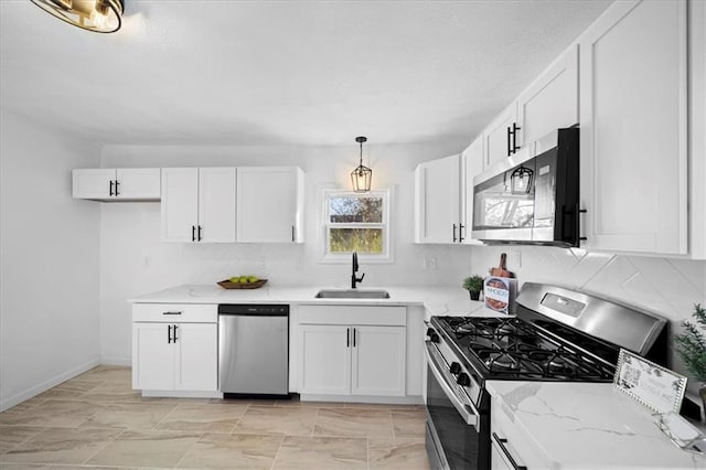 kitchen with stainless steel appliances, white cabinetry, sink, and decorative light fixtures