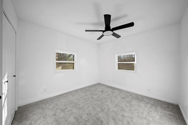 spare room with ceiling fan and carpet floors