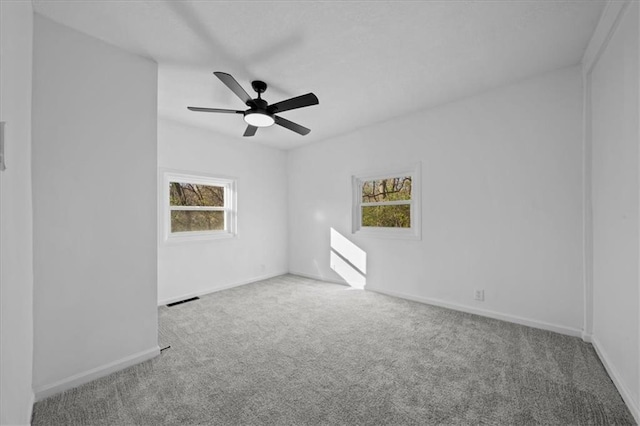 unfurnished room with carpet and ceiling fan