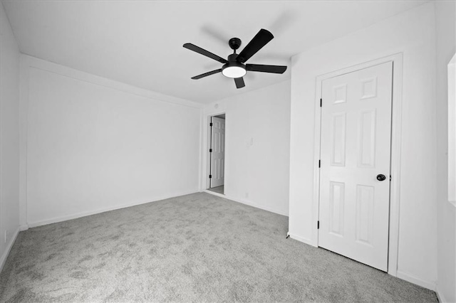 interior space featuring light colored carpet and ceiling fan