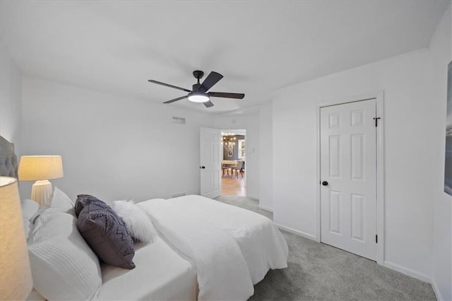 bedroom with light colored carpet and ceiling fan