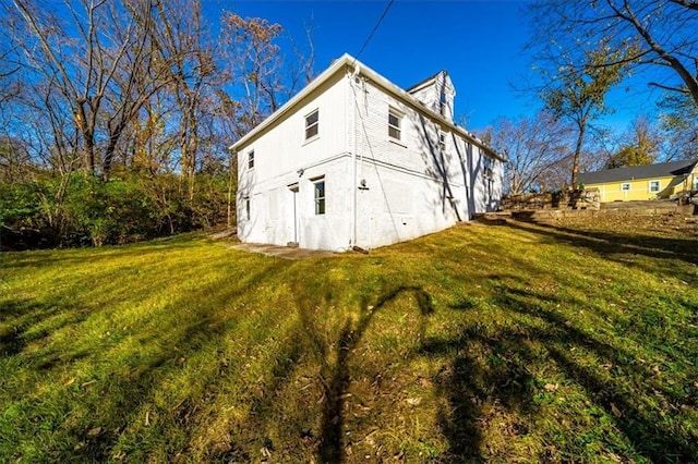 view of home's exterior with a yard