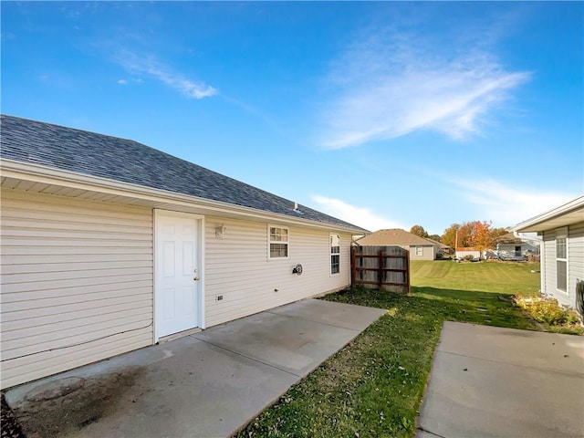 back of property with a patio and a yard