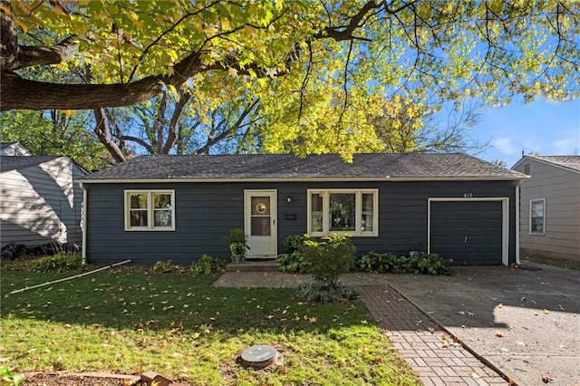 ranch-style home featuring a garage and a front lawn