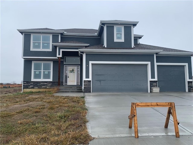 422 Victory Cir, Kearney, MO 64060 - prairie-style home featuring stone siding, concrete driveway, stucco siding, and a shingled roof
