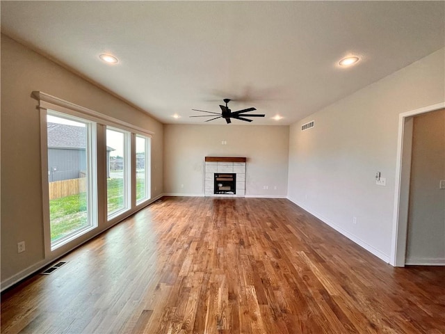 422 Victory Cir, Kearney, MO 64060 - unfurnished living room featuring a ceiling fan, wood finished floors, a fireplace, baseboards, and recessed lighting