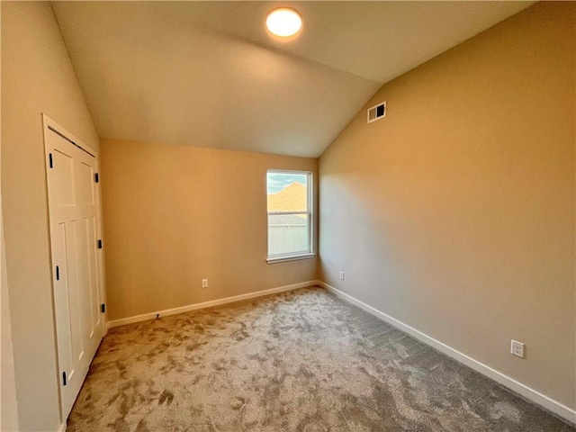 interior space with carpet and lofted ceiling