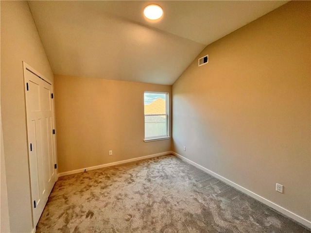 422 Victory Cir, Kearney, MO 64060 - unfurnished bedroom featuring vaulted ceiling, carpet floors, and baseboards
