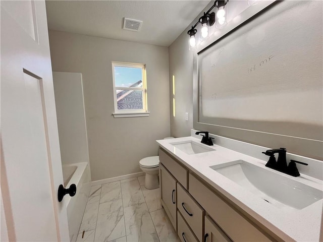 422 Victory Cir, Kearney, MO 64060 - bathroom featuring marble look tiles, double vanity, toilet, and baseboards
