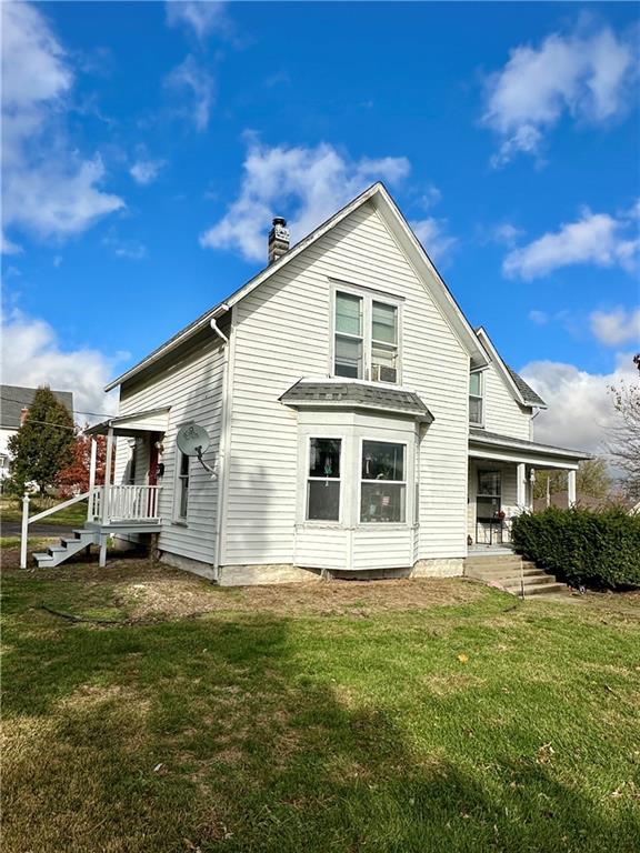 rear view of house with a yard