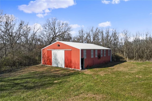 view of outbuilding featuring a lawn