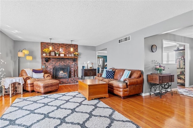 living room with hardwood / wood-style floors and a textured ceiling