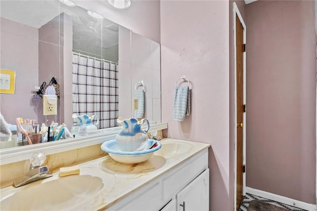 bathroom with a shower with shower curtain and vanity