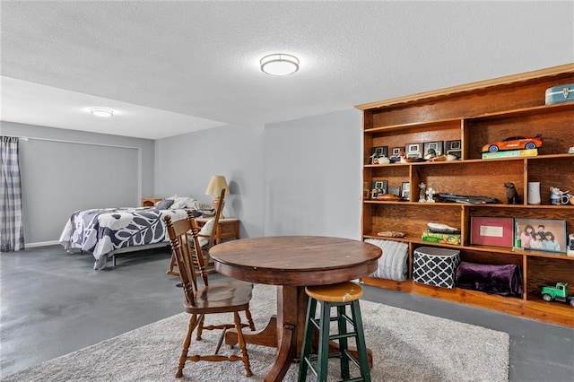 dining room with concrete flooring and a textured ceiling