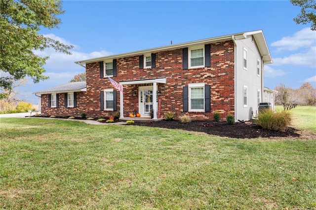 colonial inspired home featuring a front lawn