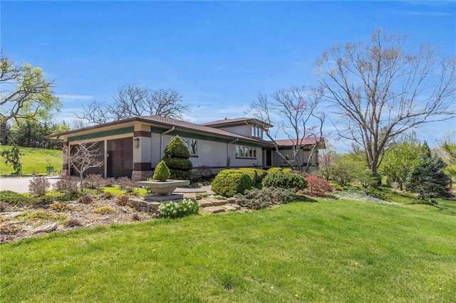 32225 W 88th St, De Soto, KS 66018 - view of side of property featuring an attached garage, a yard, stucco siding, and stone siding