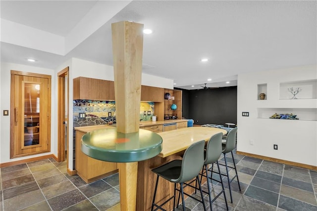 32225 W 88th St, De Soto, KS 66018 - kitchen with baseboards, light countertops, a kitchen breakfast bar, stone finish floor, and recessed lighting