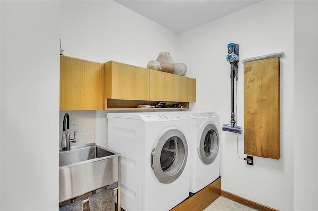 32225 W 88th St, De Soto, KS 66018 - laundry area with baseboards, independent washer and dryer, a sink, and cabinet space