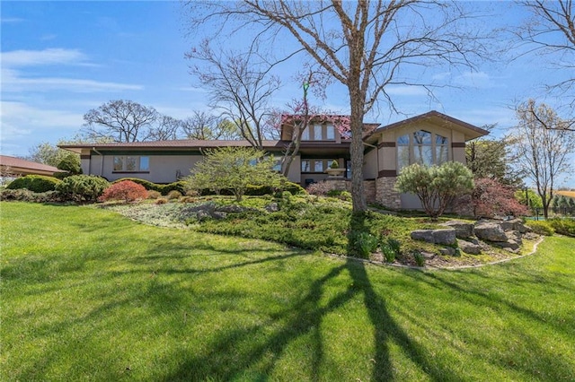 32225 W 88th St, De Soto, KS 66018 - rear view of house with stucco siding, stone siding, and a lawn