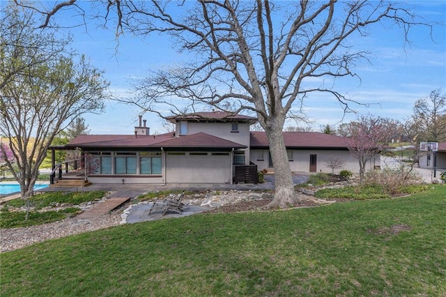 32225 W 88th St, De Soto, KS 66018 - rear view of house featuring a patio, an outdoor pool, stucco siding, and a lawn