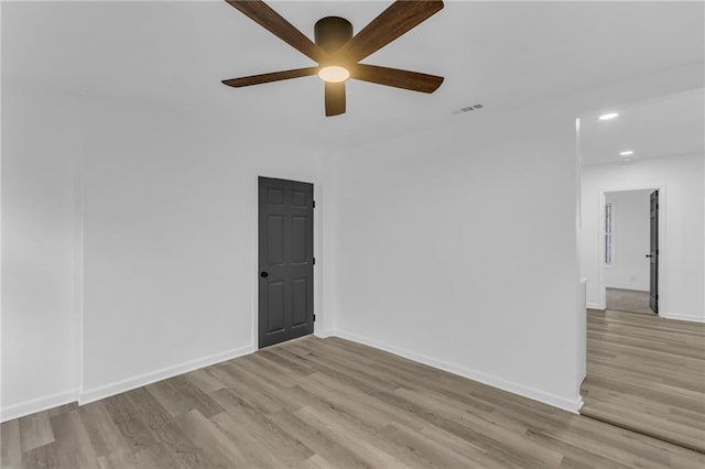 empty room with light hardwood / wood-style floors and ceiling fan