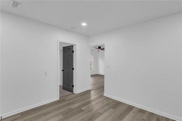 spare room featuring ceiling fan and light hardwood / wood-style floors