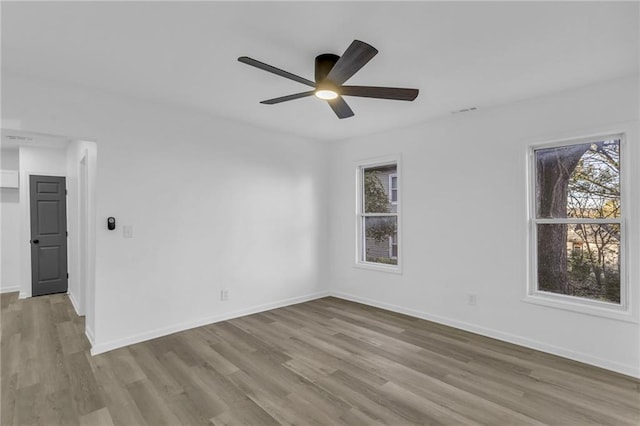 empty room with light wood-type flooring and ceiling fan