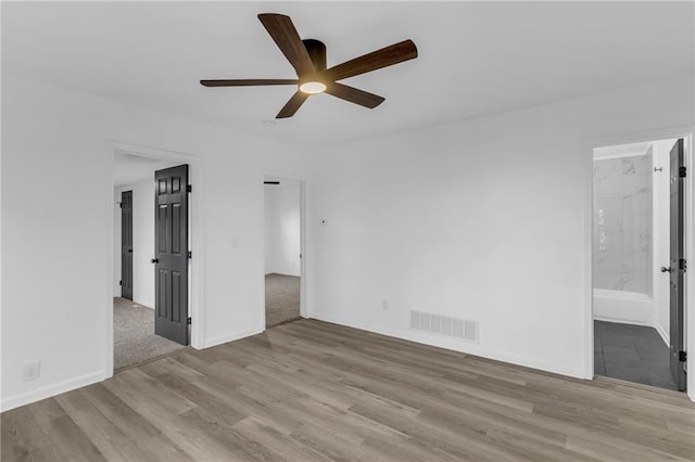 spare room featuring light wood-type flooring and ceiling fan