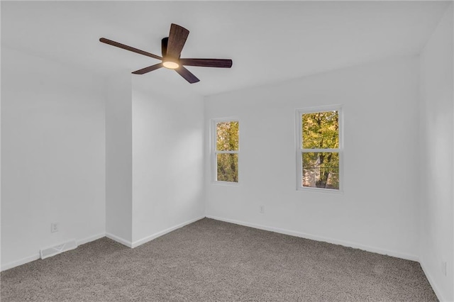 carpeted spare room with ceiling fan