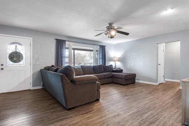 living room with ceiling fan and dark hardwood / wood-style flooring