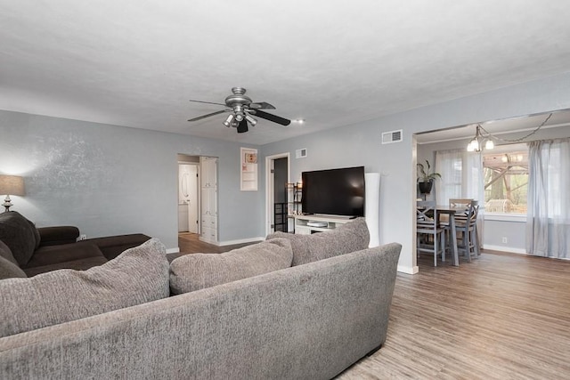 living room with hardwood / wood-style flooring and ceiling fan