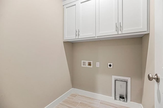 laundry area with hookup for a washing machine, cabinet space, baseboards, and hookup for an electric dryer