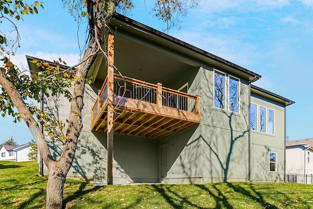 back of house with a yard and a wooden deck