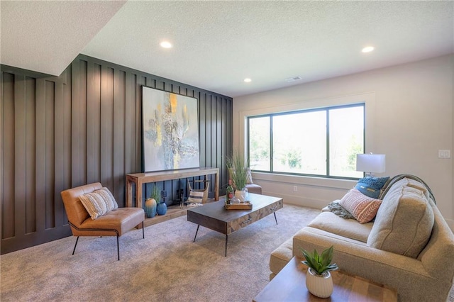 living room featuring light colored carpet and a textured ceiling