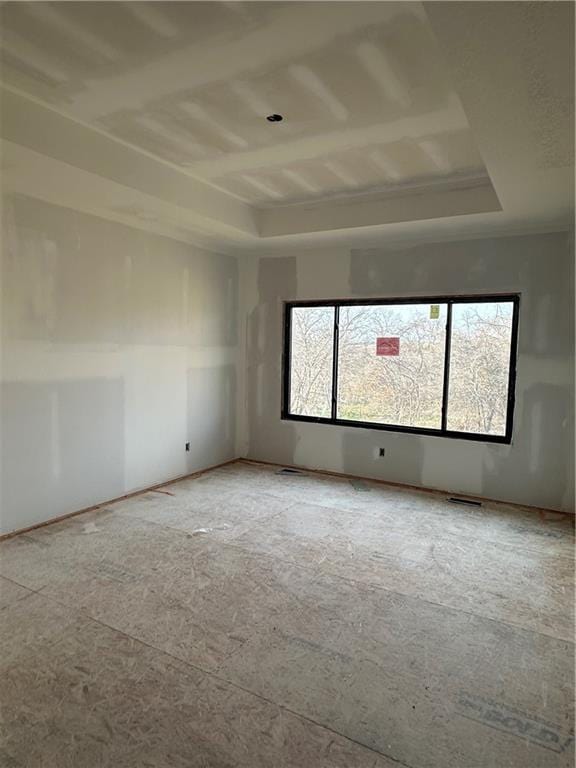 spare room featuring a raised ceiling