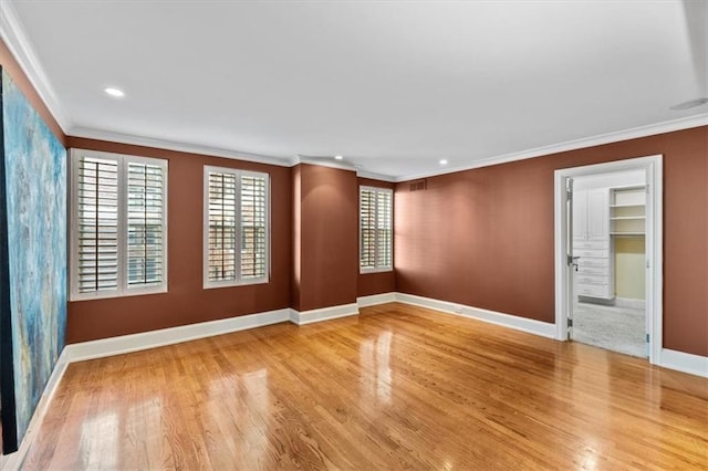 unfurnished room with wood-type flooring and crown molding