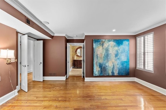 interior space featuring light wood-type flooring and crown molding