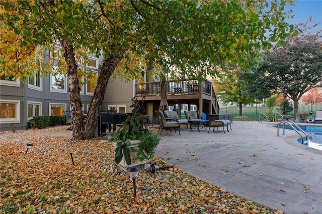 back of property featuring a swimming pool side deck and a patio area