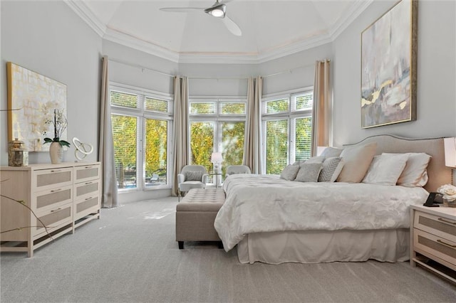 carpeted bedroom featuring ornamental molding, multiple windows, and ceiling fan