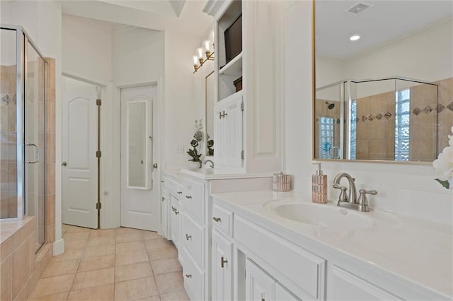 bathroom with vanity, a shower with door, and tile patterned floors